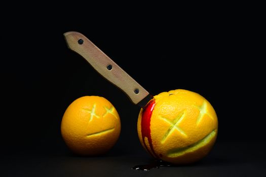 Photo of a crime with two actors - murderer and bystander. Illustrated with two oranges. Creative photography.