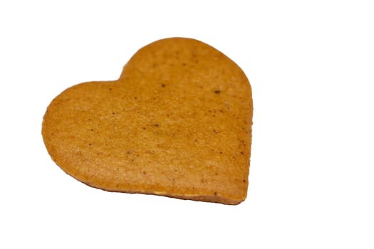 Photo of a gingerbread cookie isolated on white background. Located at a left corner of a screen. Food photography.