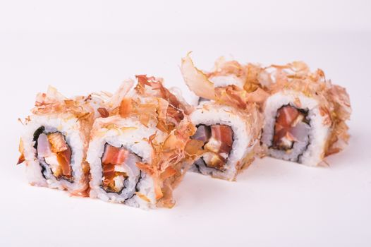 salmon sushi roll in tuna flakes  isolated on white background 