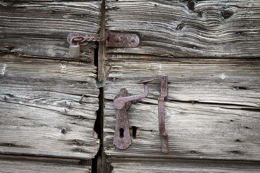 old wooden door with  handle an padlock