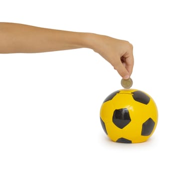 Closeup of woman's hand inserting coin in moneybox

