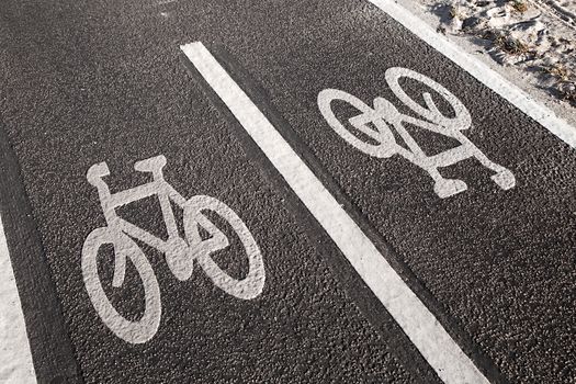 Bicycle lane sign on asphalt surface