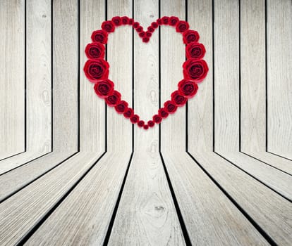 Heart Frame from red rose on wood