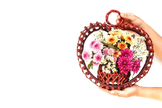 Hand holding Flower in wooden handmade basket isolated on white background