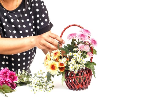 Hand holding Flower in wooden handmade basket isolated on white background