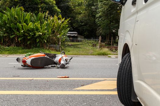 PHUKET, THAILAND - NOVEMBER 3 : Van accident on the road and crashed with motorcycle which causing the rider serious injury. November 3, 2014 in Phuket Thailand.