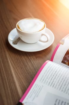 Coffee cup and book on the table