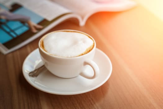 Coffee cup and book on the table
