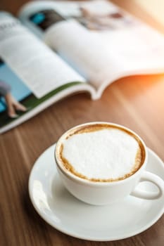 Coffee cup and book on the table