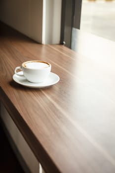 Coffee cup and book on the table
