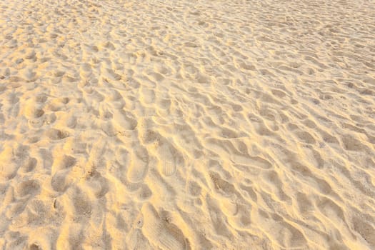 Texture of sand and footprints in the sand