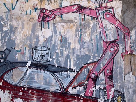 Creative funny graffiti of a robot on a wall of old building