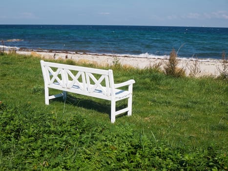 Classical vintage wooden bench seating corner on a beautiful beach     