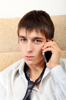 Teenager with Cellphone on the Sofa at the Home