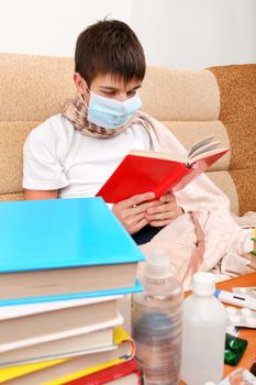 Sick Teenager in Flu Mask with the Books on the Sofa