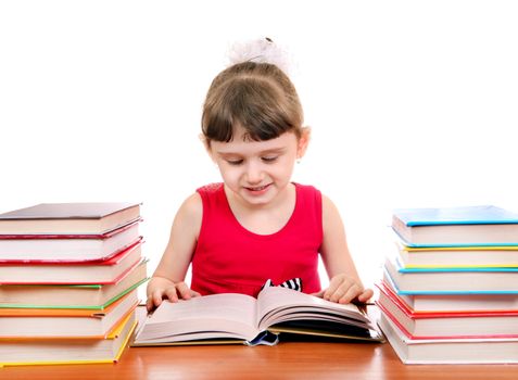 Cheerful Little Girl with the Books at the Desk on the White Background