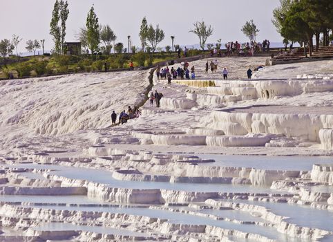 HIERAPOLIS, ANATOLIA, TURKEY - APRIL 20: Unidentified international tourists explore salt pools and springs on April 20, 2012 in Hierapolis, Turkey.