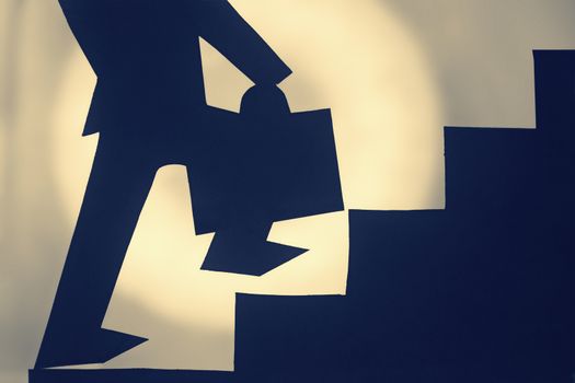 Businessman stepping up a staircase