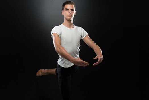 Handsome Male Ballet Dancer On A Black Background