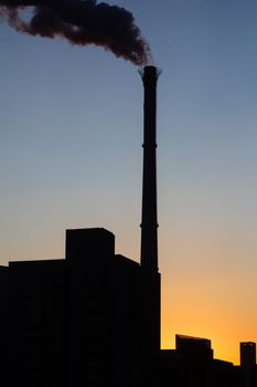 Chimney is smoking, under the twilight