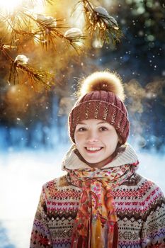 Portrait of the beautiful girl in the winter wood