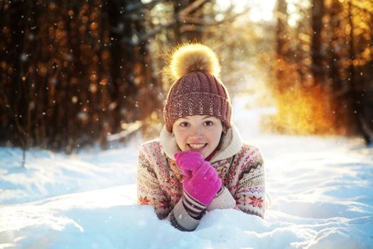 Portrait of the beautiful girl in the winter wood