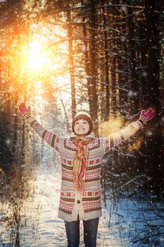 Portrait of the beautiful girl in the winter wood