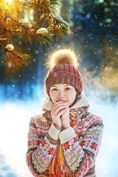 Portrait of the beautiful girl in the winter wood