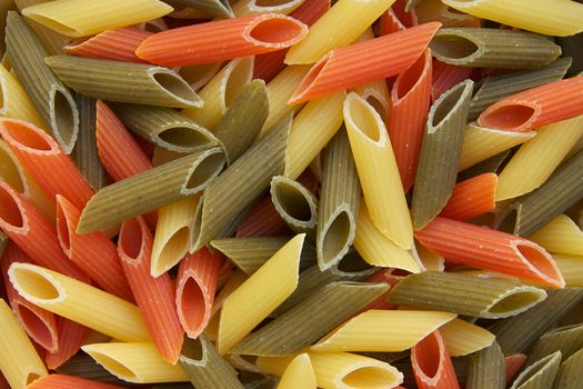 Raw three-coloured Italian pasta. Background