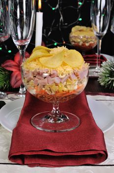 Festive layered salad in a glass goblet