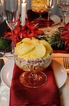 Festive layered salad in a glass goblet