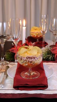 Festive layered salad in a glass goblet