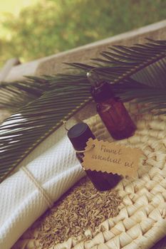 A dropper bottle of fennel essential oil. Fennel grains in the background