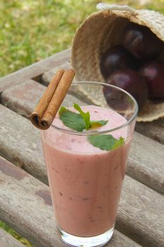 Drinkable plum yogurt on the old wooden surface