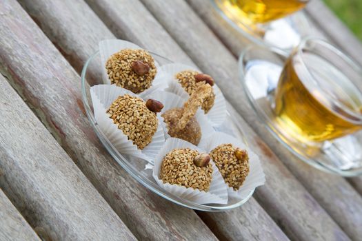 Fitness dessert -  homemade diet truffles with dried fruits and nuts on the glass plate