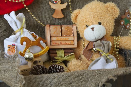 A wooden made calendar with inscription "December 25. Merry Christmas!!!" in an old case with other Christmas decorative items