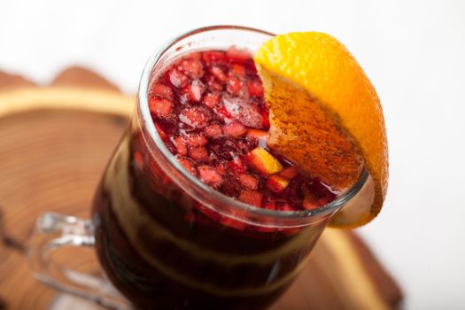 Traditional winter sweet hot alcohol drinks mulled red wine  glintwine with orange, spices, cinnamon, rosemary, anise served on wooden board