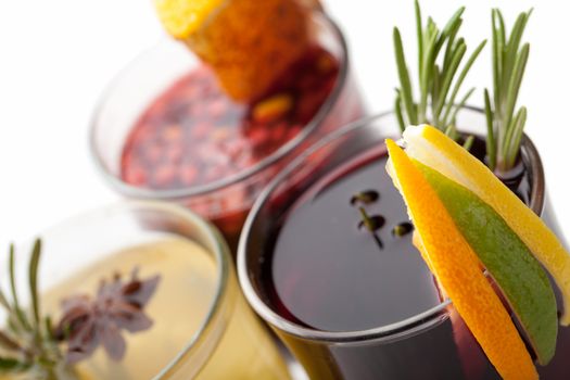 Variety of traditional winter sweet hot alcohol drinks mulled red wine  glintwine and  white rum with orange, spices, cinnamon, rosemary, anise