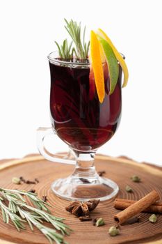 Traditional winter sweet hot alcohol drinks mulled red wine  glintwine with orange, spices, cinnamon, rosemary, anise served on wooden board