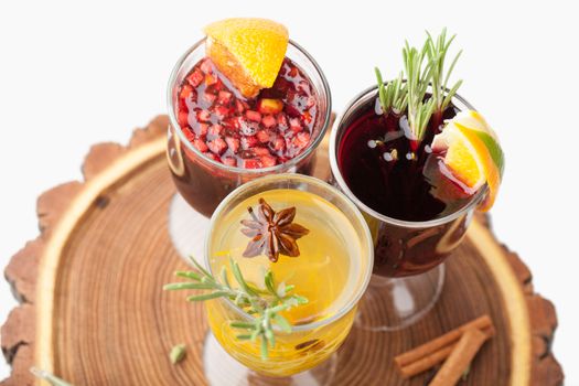 Variety of traditional winter sweet hot alcohol drinks mulled red wine  glintwine and  white rum with orange, spices, cinnamon, rosemary, anise served on wooden board