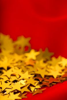 Gold stars on red fabric. macro shooting