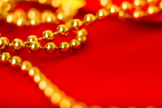 Gold beads on red fabric. macro shooting
