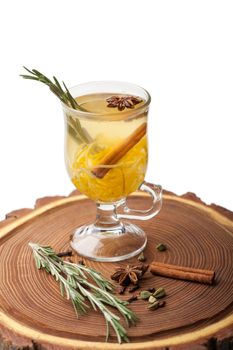 Traditional winter sweet hot alcohol drinks mulled white rum with orange, spices, cinnamon, rosemary, anise served on wooden board