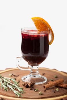 Traditional winter sweet hot alcohol drinks mulled red wine  glintwine with orange, spices, cinnamon, rosemary, anise served on wooden board
