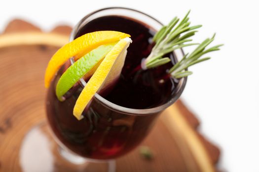 Traditional winter sweet hot alcohol drinks mulled red wine  glintwine with orange, spices, cinnamon, rosemary, anise served on wooden board