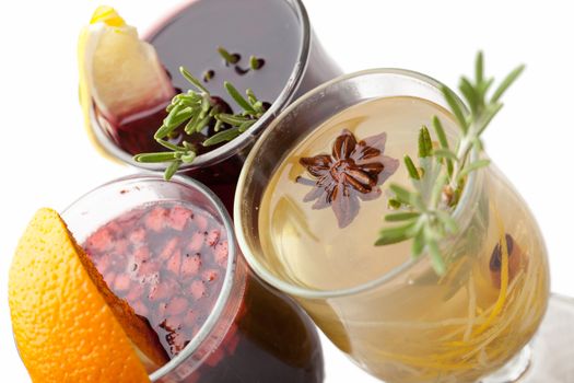 Variety of traditional winter sweet hot alcohol drinks mulled red wine  glintwine and  white rum with orange, spices, cinnamon, rosemary, anise