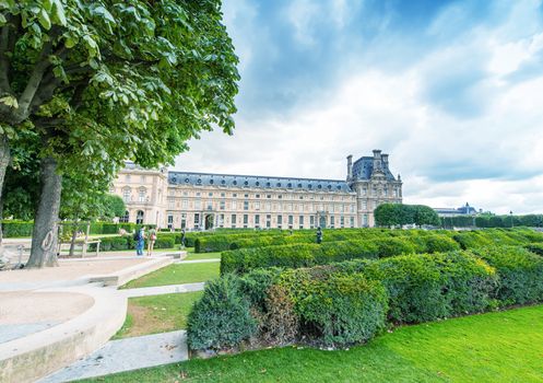 PARIS - JUNE 15, 2014: Tourists in Tuileries Gardens on a summer day. Paris is visited by more than 30 million people every year.