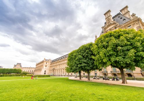 PARIS - JUNE 15, 2014: Tourists in Tuileries Gardens on a summer day. Paris is visited by more than 30 million people every year.