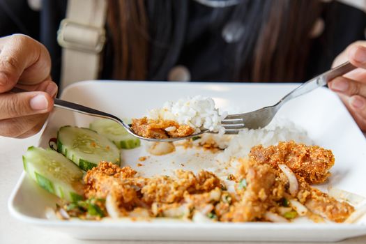 Hand holding spoon and fork in the restaurant