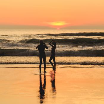 Silhouette of tourist at sunset beach in Phuket Thailand